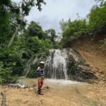 Waterfall stop during a Lombok dirt bike tour, perfect for family adventures.